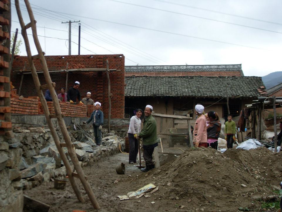 Some villagers working on the construction site of a recreational building.